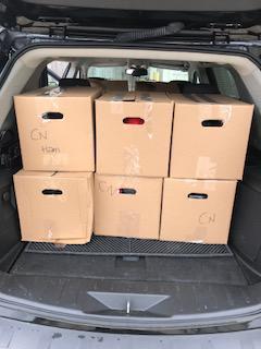 boxes of food in the back of a vehicle being delivered