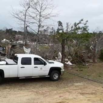 search and rescue response vehicle in front of storm debris